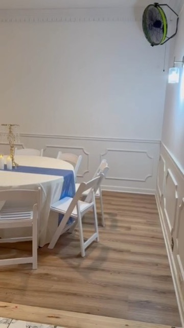 Intimate banquet table setting with crisp white linens and blue table runner against classic wall molding